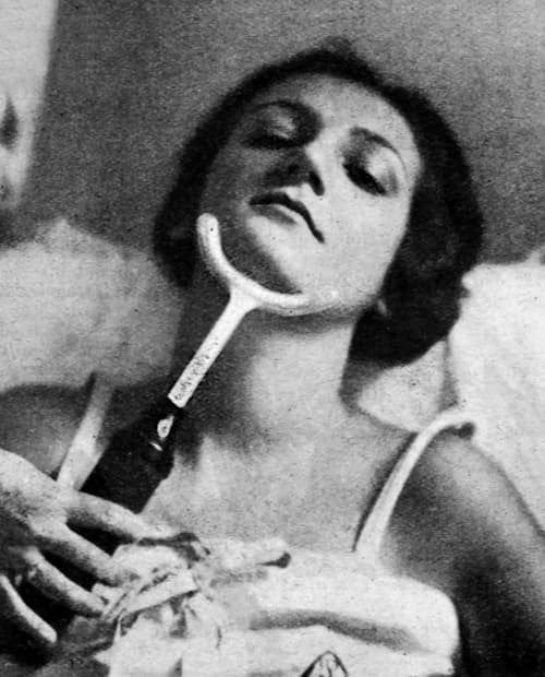 1929 High-frequency electrode being used to treat a double chin