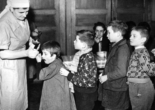 1940 Children being fed cod liver oil